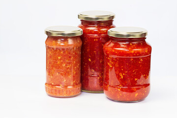Fototapeta na wymiar Hot sauce with chili peppers and spicy spices in jars