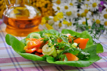 Vegetable salad with arugula on the kitchen table.