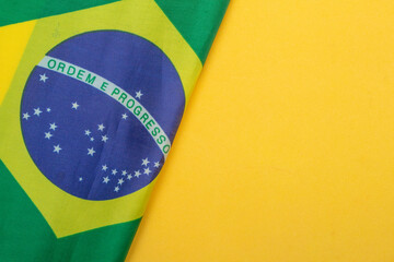 LAURO DE FREITAS, BRAZIL - August 19, 2022 : brazilian flag under yellow background