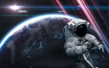 Obraz na płótnie Canvas Astronaut in outer space. Distant habitable planet in light of bright star. Science fiction. Elements of this image furnished by NASA