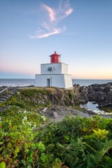 Fototapeta na wymiar Amphitrite Point Lighthouse at the coast of Vancouver Island, British Columbia, Canada