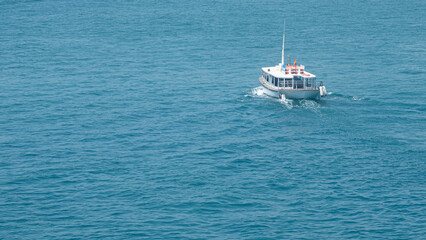 Small boat sailing through the Mediterranean sea