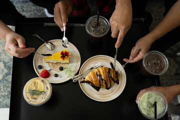 Family eating party in the cafe.Enjoying friends drink cool drink menu, coffee, chocolate and green tea on wooden table at restaurant.Coffee shop menu concept.