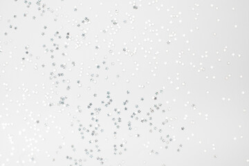 sparkles silver stars on white background with text place- Image