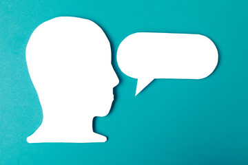  paper face and speech bubble on colorbackground copy space for text, communication, symbolic- Image