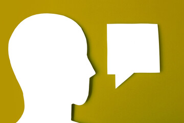  paper face and speech bubble on colorbackground copy space for text, communication, symbolic- Image