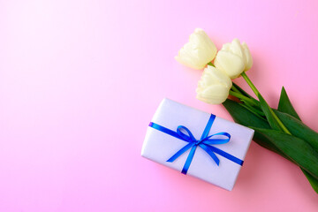 Gift box and spring flowers on pink background. Stylish soft image of spring flowers. Happy womens day. Happy Mothers day.Hello Spring- Image