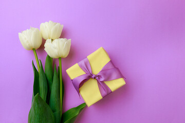 Gift box and spring flowers on color background. Stylish soft image of spring flowers. Happy womens day. Happy Mothers day.Hello Spring- Image