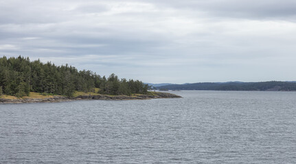 Islands surrounded by ocean and mountains. Summer Season. Gulf Islands near Vancouver Island, British Columbia, Canada. Canadian Landscape.