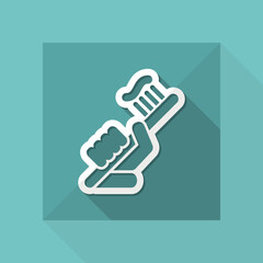 Hand holding toothpaste and toothbrush