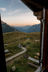 Fototapeta na wymiar View from the window of the hut into the valley of Oberstdorf at morning sunrise.