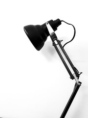 Black desk lamp on white empty background, copy space for text template.