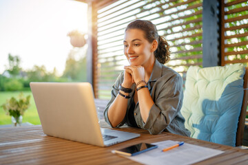 woman is working sitting on the patio