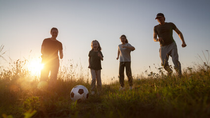 Happy family playing soccer