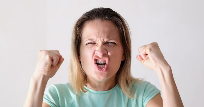 The woman clenched her fists and yells