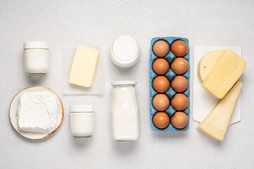 Variety of dairy products on white background. Bottle of milk, cheese, butter, yogurt or sour cream, cottage cheese. Farm dairy products concept