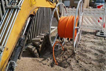 Orange fiber optic cables laid in the ground, buried cables for faster internet in rural regions. ...