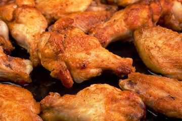Many fried, sliced chicken wings, with crispy crust. Tasty healthy dinner on domestic kitchen. - 524913942