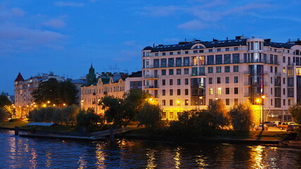 Urban landscapes. Night view of the embankment, the river and the buildings of St. Petersburg. Russia.