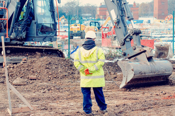 Excavator and workers at construction site