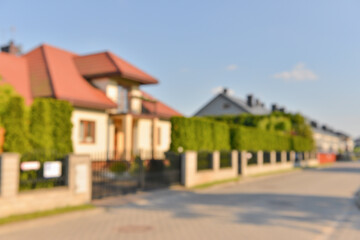 Fototapeta na wymiar Blurred view of beautiful houses on sunny day