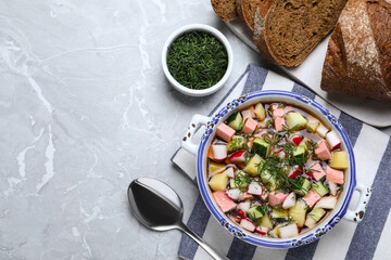 Delicious cold okroshka with kvass served on grey table, flat lay and space for text. Traditional Russian summer soup
