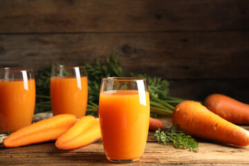 Freshly made carrot juice on wooden table