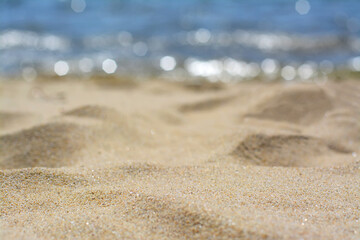 Sandy beach near sea on sunny day, closeup