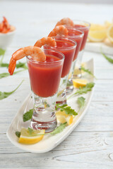Shrimp cocktail with tomato sauce on white wooden table