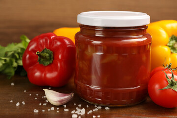 Delicious lecho and fresh ingredients on wooden table, closeup