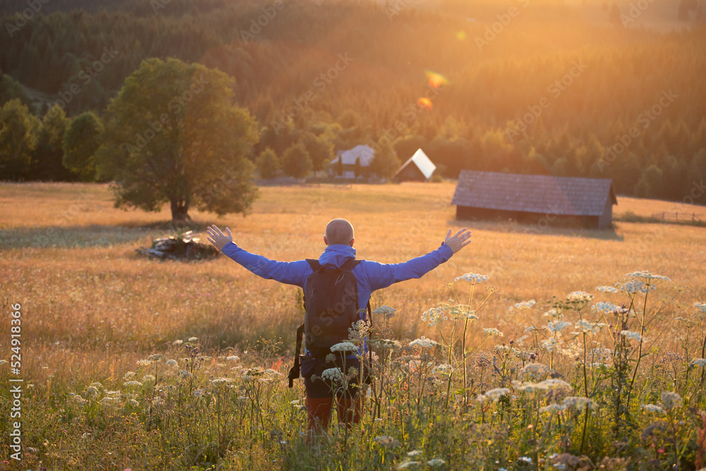 Wall mural Joyful male tourist relaxing in nature