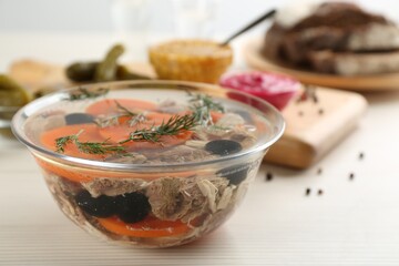 Delicious aspic with meat on white wooden table, closeup