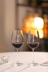 Glasses of wine for romantic dinner on table in restaurant
