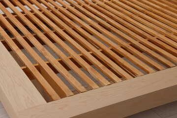 Closeup view of new wooden bed frame indoors