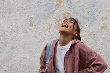 Obraz premium Outdoor portrait of smiling teenage girl with positive emotions.