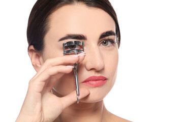 Woman using eyelash curler on white background