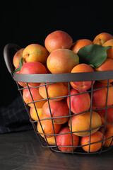 Delicious fresh ripe apricots on grey table