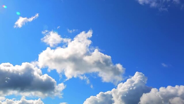 White clouds in the blue sky background. Timelapse. Sunny day. Partly cloudy. Weather forecast. Sunlight. Cloudscape. Wind move. Cyclone and anticyclone. HD video footage. Atmosphere pattern. Heavens.