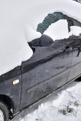 Car under the snow., winter weather vehicle. Cars blocked by snow on roads, street snow-paralysis of traffic.
