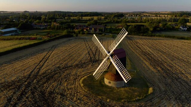 Windmill in UK. Old inactive wooden windmill. Historic traditional typical old windmill on the rural countryside. Aerial. 