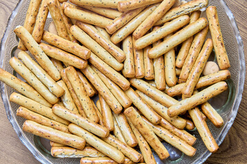 Sticks of crispy bread with poppy seeds, texture for background.
