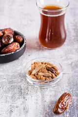 Bowl with date pit powder for making coffee on the table. Caffeine Free Alternative to Coffee. Vertical view