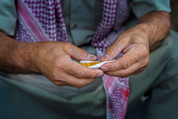 Hands rolling cigarette, Southeastern Turkey