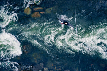 Obraz premium Top view kayaker on mountain rough river, extreme kayak boat, aerial drone photo