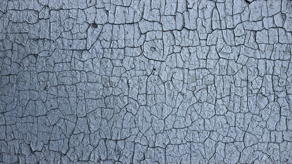 Cracks of old paint on a painted wall. Close up. Background, texture