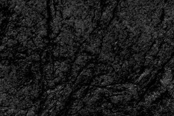 Texture of black stone rock. Cracks in stone surface.