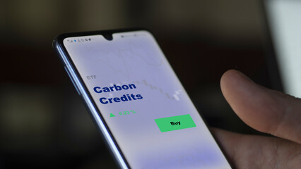 Carbon credits etf fund on screen. A phone shows the ETF's prices entreprises business Paris...