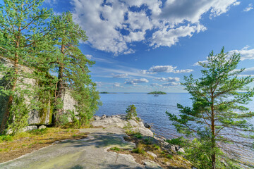 Beautiful stones and pine trees on the lake. Landscape of wild nature.