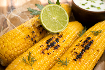 Grilled corn on old background