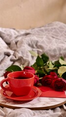 Background Festive Flatlay, composition for Valentine's Day on February 14. Coffee in a red cup, red rose flowers and diamond heart earrings